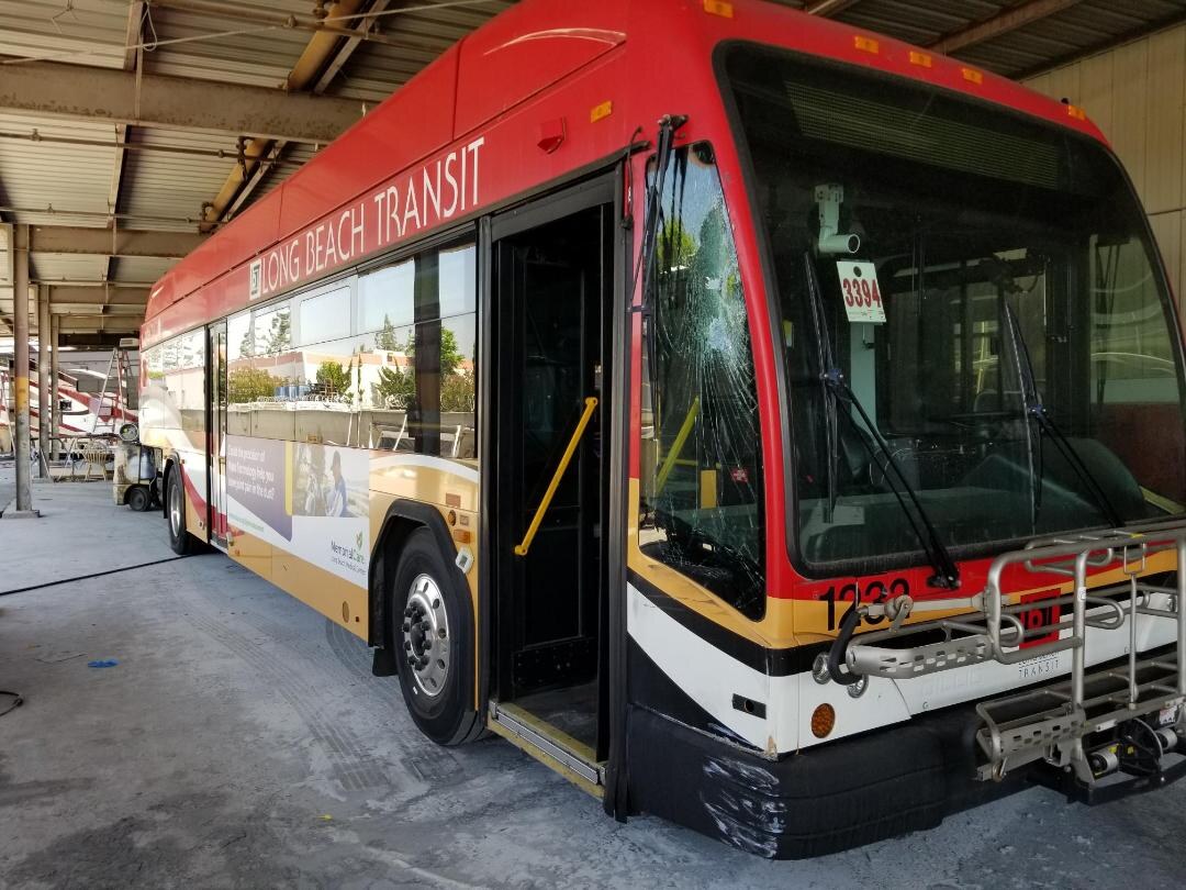 Long Beach Transit Gillig 1232 with a shattered windshield and scuffed front bumper before repair