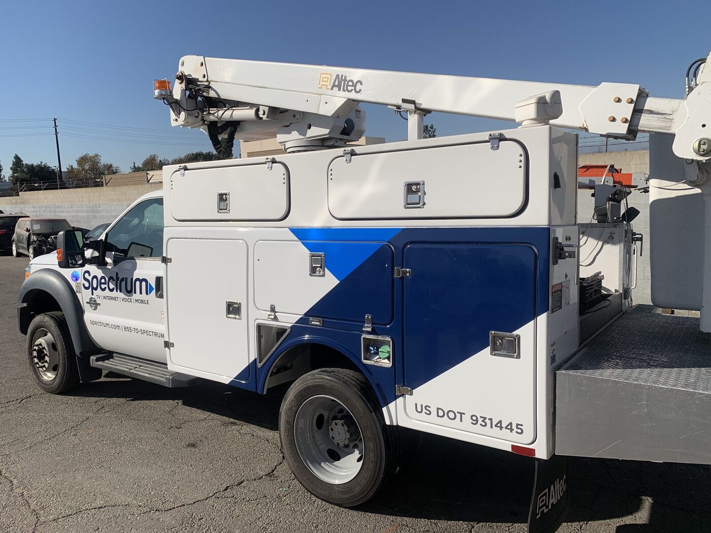 Spectrum F-450 bucket truck after utility body repair, repaint and graphics