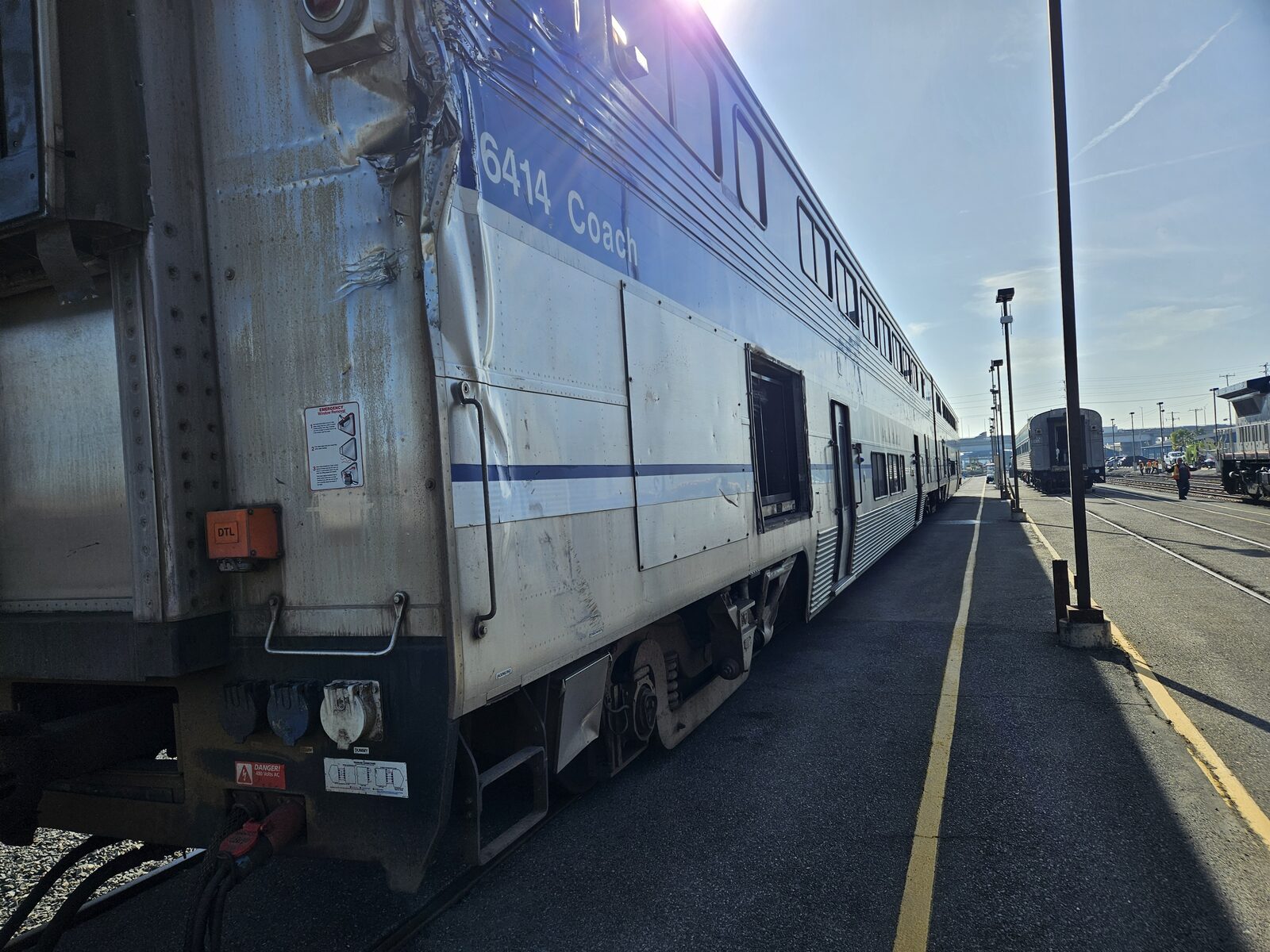 Rail coach car with collision damage before repair