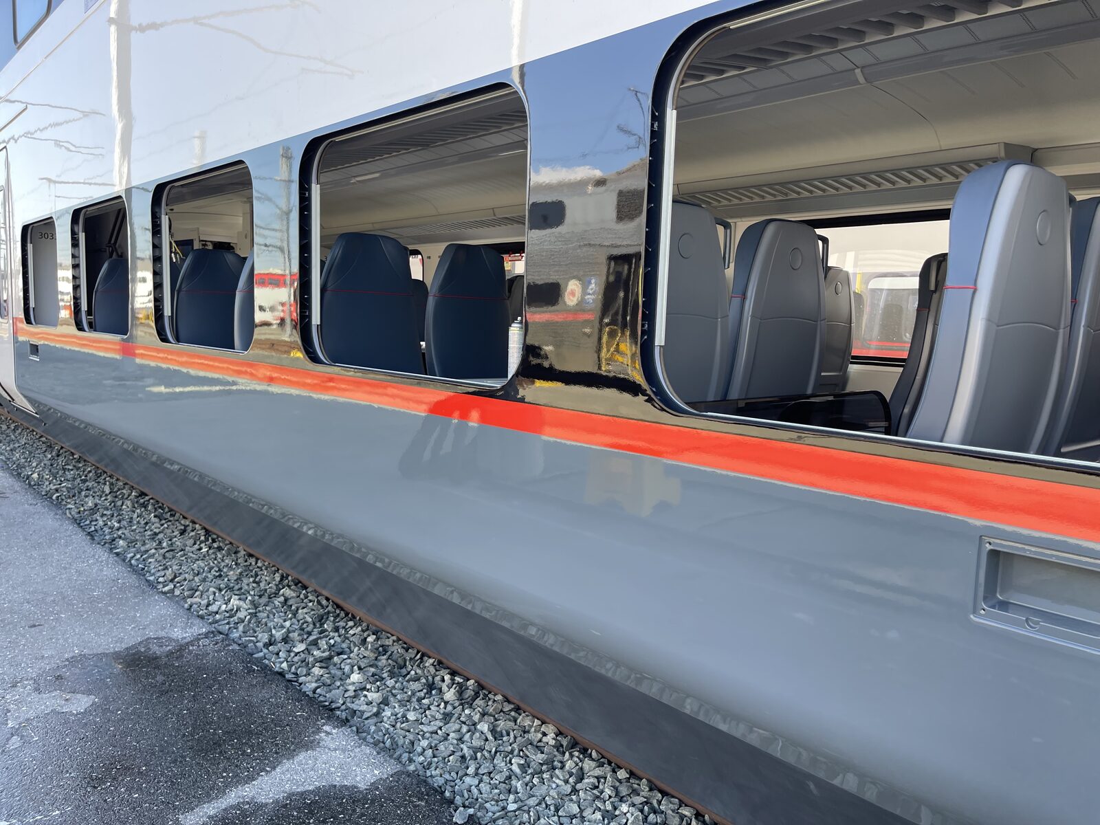 Caltrain cab car with windows out during repaint